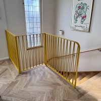 Smidesräcke inomhus modell Zigzak i signalgul RAL 1003. Anpassade längder 120–80–110 cm, höjd 100 cm, kund i Mälarhöjden Inomhusräcke i smide Zigzak vid trappa, RAL 1003 signalgul, höjd 100 cm och 7-8 cm mellan stänger, stilrent trappräcke